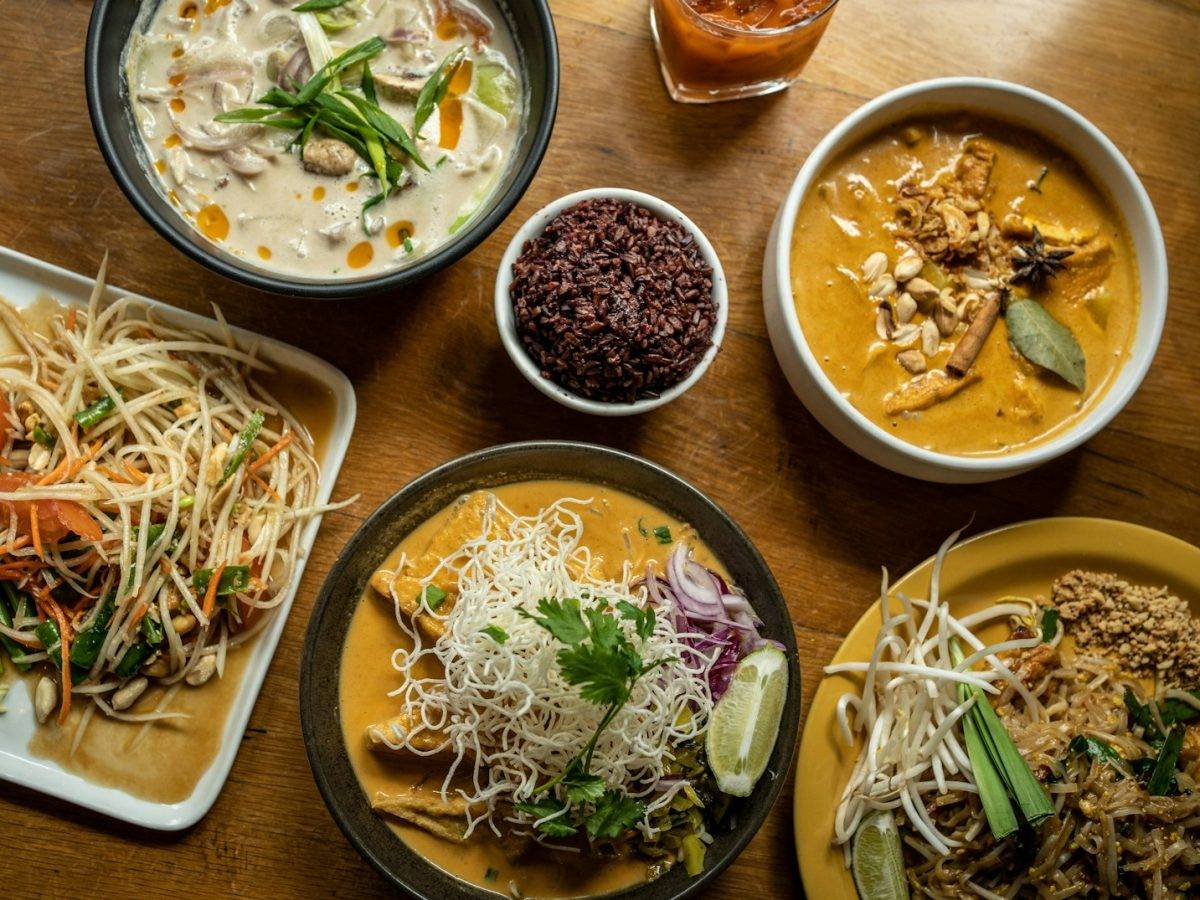 a wooden table topped with plates of food