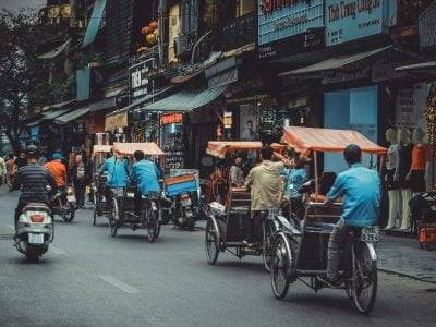 man driving white motor scooter on road