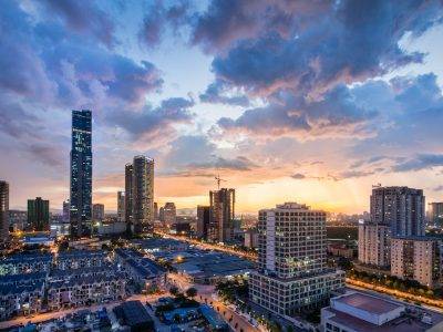 gray high-rise buildings under gray clouds during golden hour