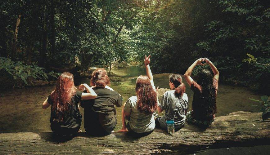 Five Women Sitting On Tree Trunk