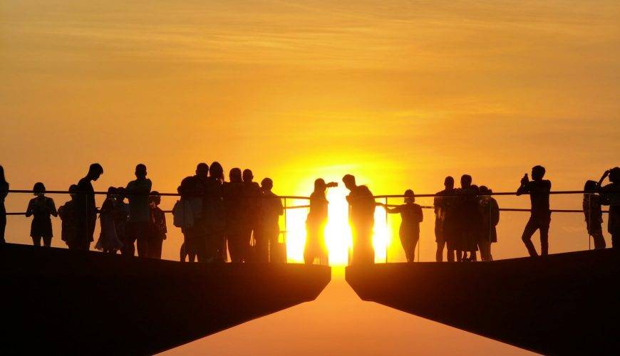 a group of people standing on top of a bridge