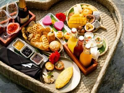 A heart shaped tray filled with food next to a pool