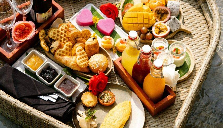 A heart shaped tray filled with food next to a pool