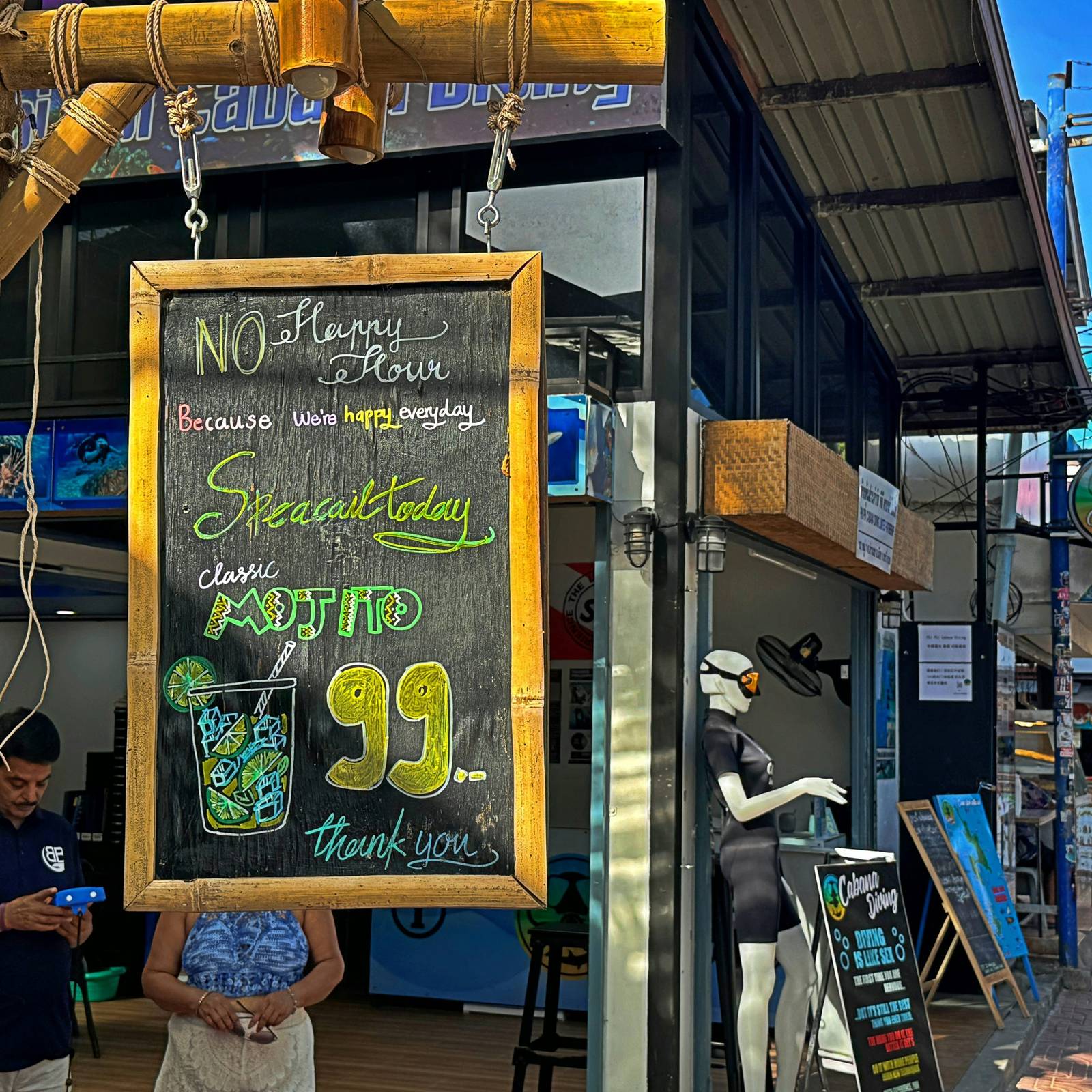 a woman standing in front of a store holding a sign