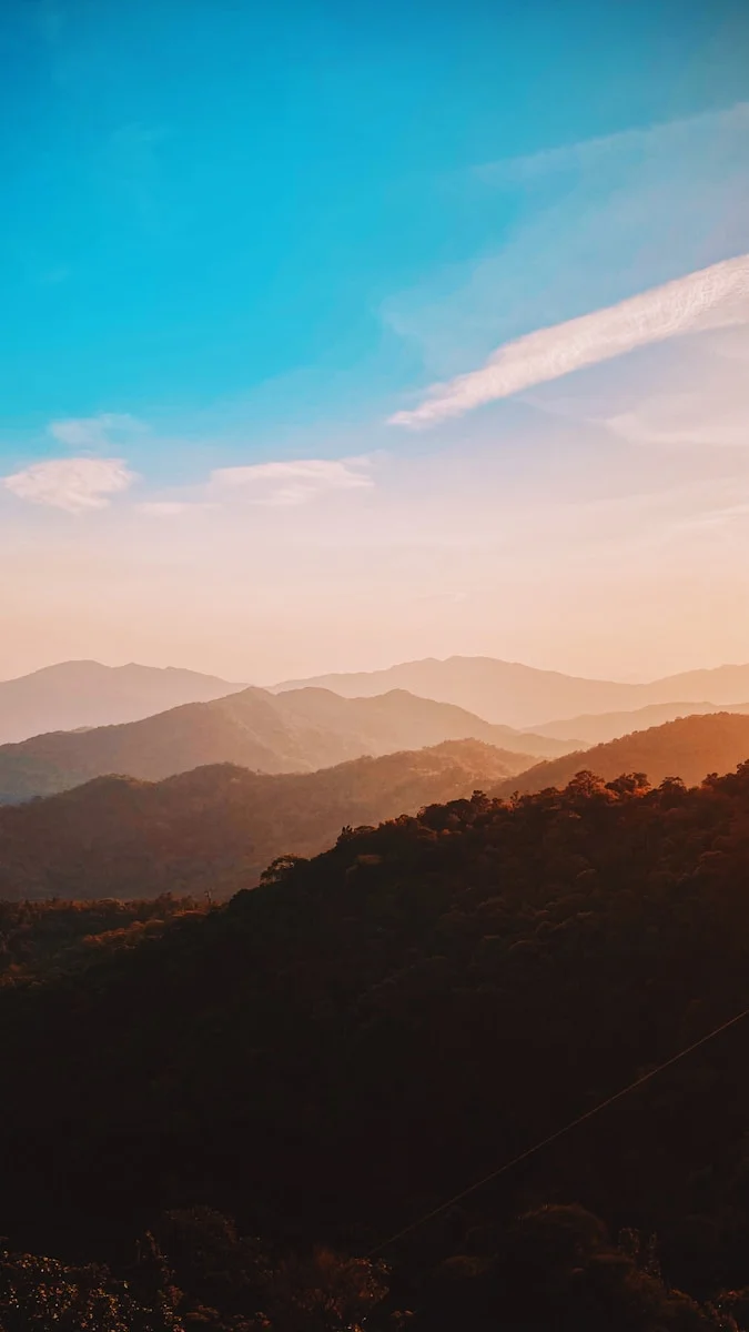 silhouette of mountains under blue sky during daytime