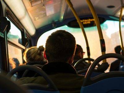 photo of man sitting inside bus