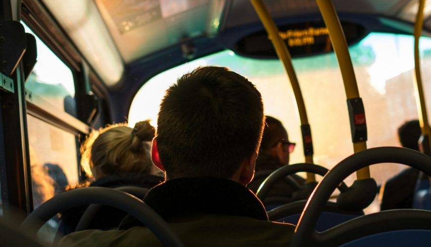 photo of man sitting inside bus