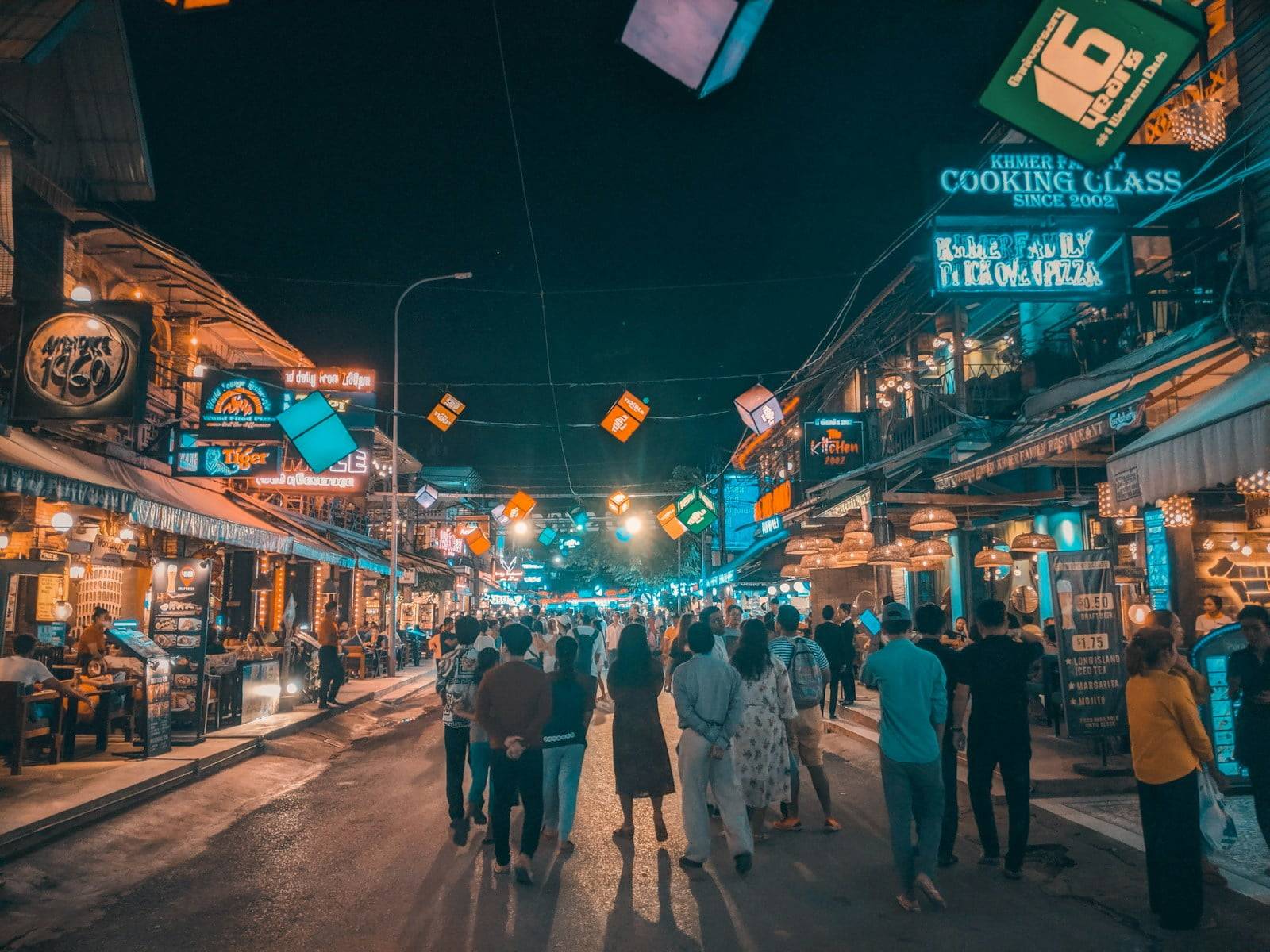 people walking in the street at night time